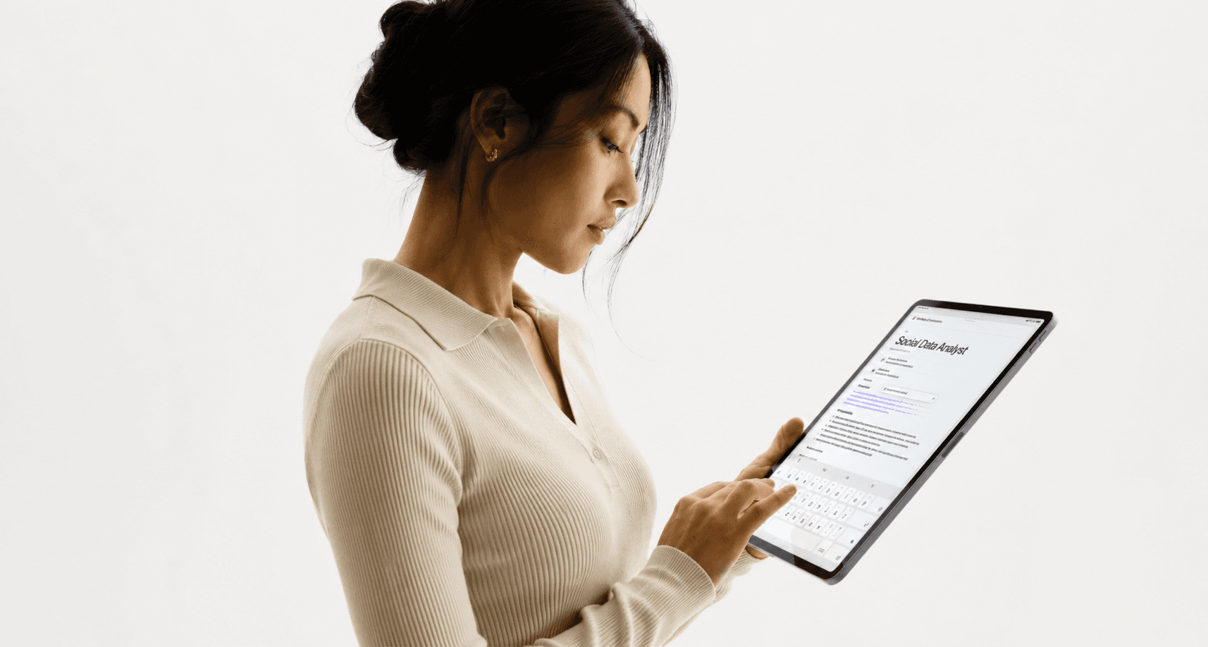 A compliance analyst reviewing figures on a tablet